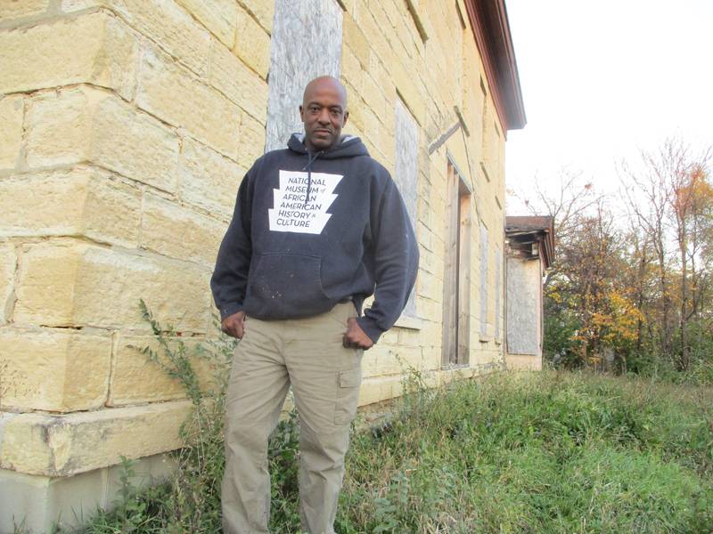 Luther Johnson stands next to the Casseday house. Johnson plans to convert the 1851 Joliet building into a museum depicting local African American history and the role of African Americans in the U.S. military. Nov. 9, 2023.