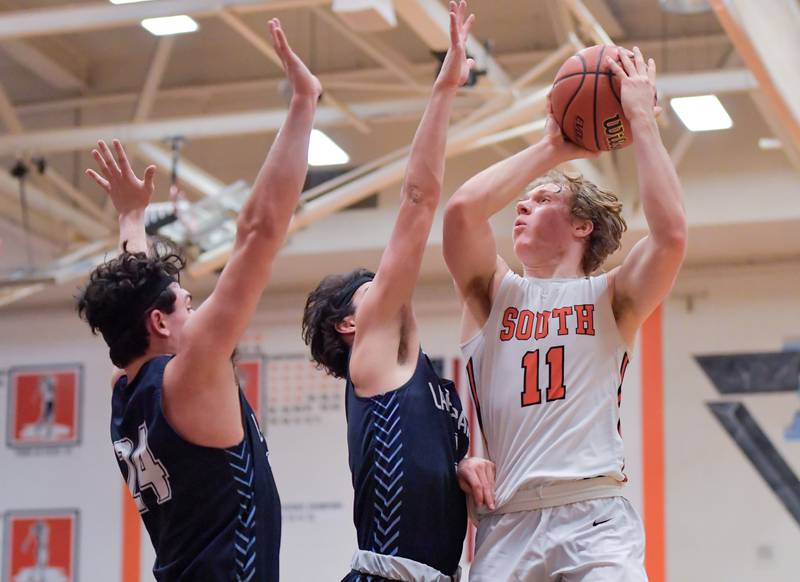 Wheaton Warrenville South's Colin Moore (11) takes a shot against Lake Park during a game on Saturday, Jan. 7, 2023.