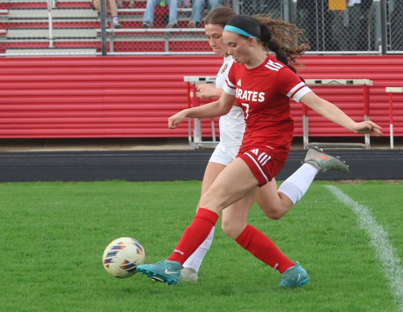 Ottawa's Georgia Kirkpatrick kicks the ball ahead of L-P's Addie Dawson on Monday, April 13, 2026 on King Field at Ottawa High School.