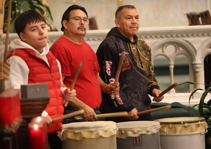 Drumers keep the beat during the Lady of Guadalupe vigil Chichimeca dance at St. Patrick's Catholic Church on Thursday, Dec. 12, 2025 in La Salle The drums symbolize the Earth's heartbeat, ancestral wisdom, and a conduit to the cosmos, connecting dancers to nature and spirits, representing power, creation, and unity, marking sacred times, and calling to ancestors, with different rhythms signaling specific intentions, all part of a spiritual dialogue with the divine and Earth.