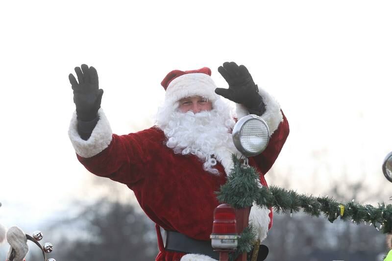 Santa waves to the people as the Joliet police, fire and public works vehicles escort him through Joliet before he heads off to the North Pole for the annual Santa Send-Off on Saturday, Dec. 14, 2024 in Joliet.