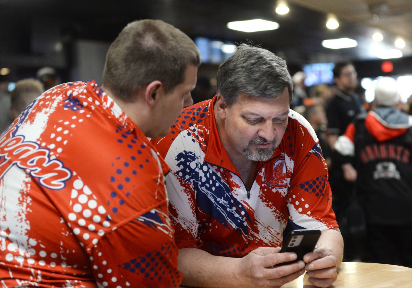 Oregon bowling coach Al Nordman (right) and his assistant coach check scores after the second game at the Harlem Regional on Saturday, Jan. 18, 2025 at Forest Hills Lanes in Machesney Park. The Hawks finished second at the regional to advance to the sectional next Saturday, Jan. 25 in Dixon.