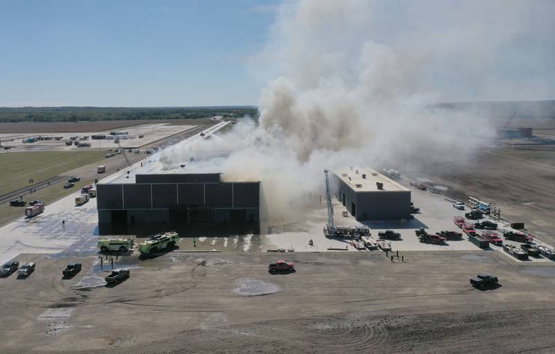 Smoke billows from Marquis Energy as firefighters work to control a structure fire on Wednesday, Oct. 8, 2025 in Hennepin. The fire was upgraded to a 5th alarm dispatching the (MABAS) Mutual Aid Box Alarm System. The fire broke out around 11a.m.