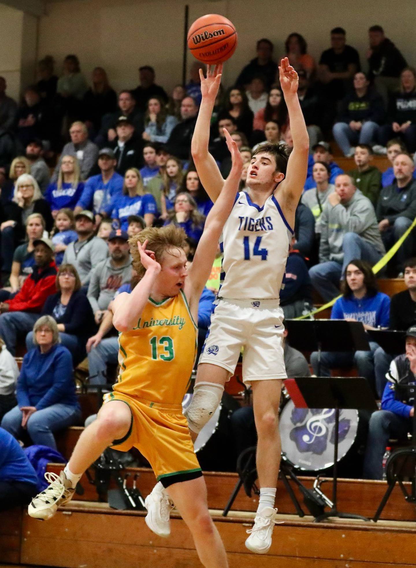 Princeton's Grady Thompson's makes a 3-pointer in front of the PHS band and gets fouled by U-High's Mason Funk at Prouty Gym Saturday night. Thompson completed the 4-point play, finishing with 22 points.