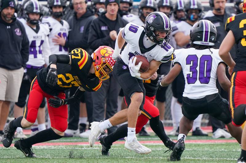 Downers Grove North's Oliver Thulin (10) returns a kick-off against Batavia’s Andrew Culotta (27) during a class 7A quarterfinal playoff football game at Batavia High School on Saturday, Nov. 16, 2024.