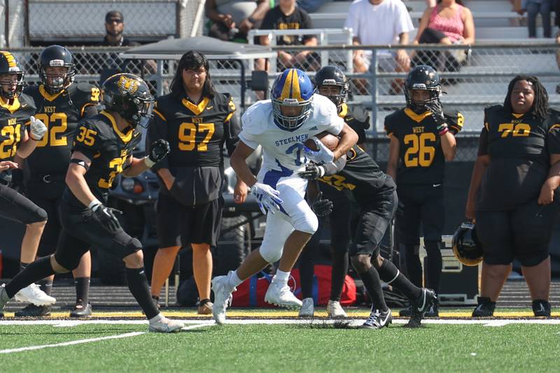 Joliet Central’s Christian Smith sheds a tackle on a catch and run against Joliet West on Saturday, Sept. 23, 2023 in Joliet.