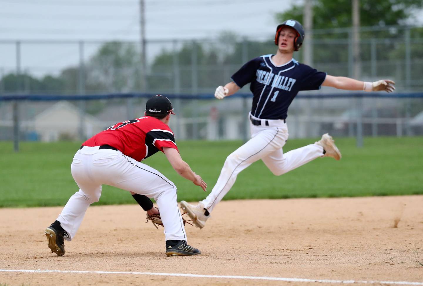 Bureau Valley's Brock Foster eludes the tag of E-P third baseman Connor Meadows in Monday's regional championship at Princeton.