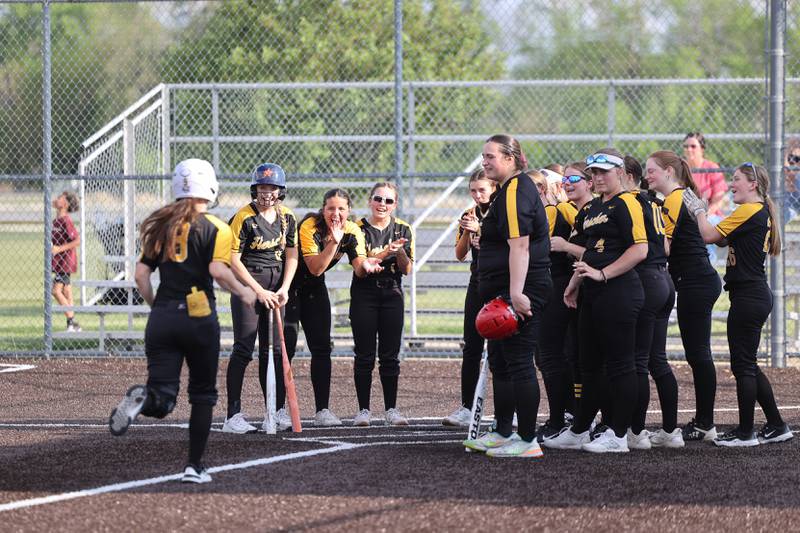 Herscher players welcome teammate Keira Ahramovich after a home run during the Tigers' 13-6 victory against Central on Wednesday, May 14, 2025.
