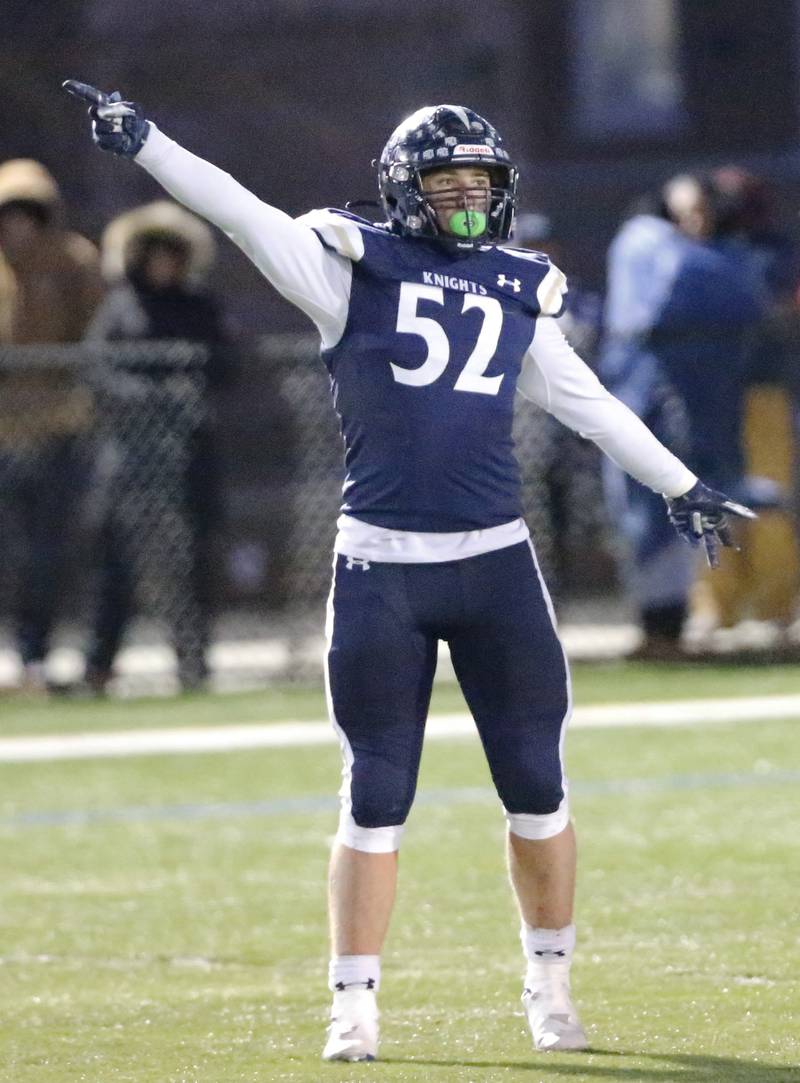 IC Catholic's Jesse Smith (52) signals a first down after a fourth down stop during the Class 3A varsity football semi-final playoff game between Byron High School and IC Catholic Prep on Saturday, Nov. 19, 2022 in Elmhurst, IL.