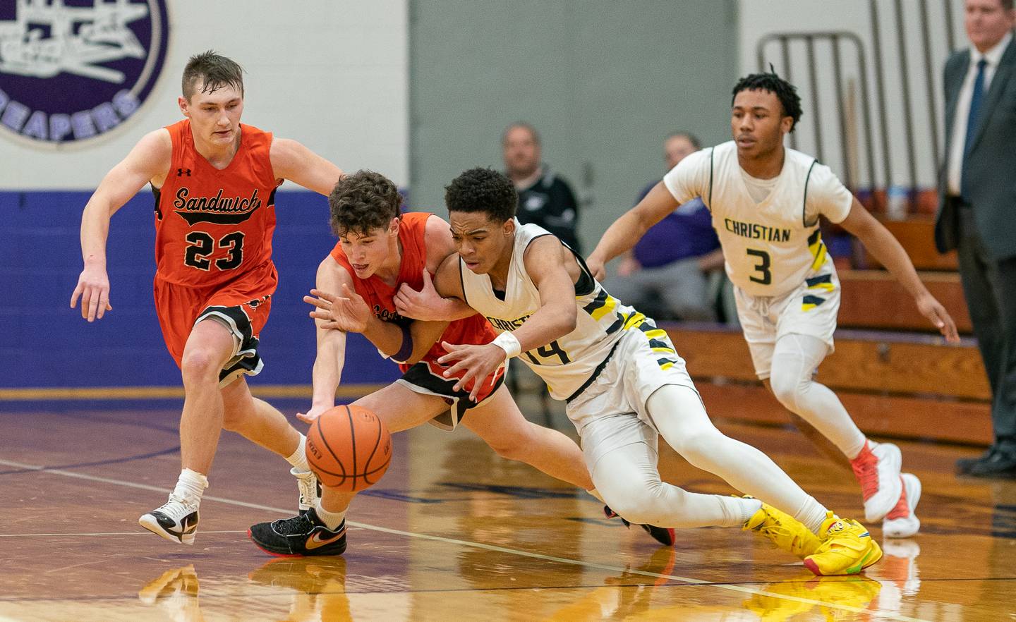 Sandwich’s Evan Gottlieb (24) pokes the ball away from Yorkville Christian's David Douglas Jr (14) during the 59th Annual Plano Christmas Classic basketball tournament at Plano High School on Tuesday, Dec 27, 2022.
