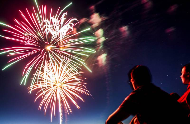 Spectators watch fireworks explode over Lions Park during the Cary Park District's summer celebration Thursday, July 3, 2014, in Cary.