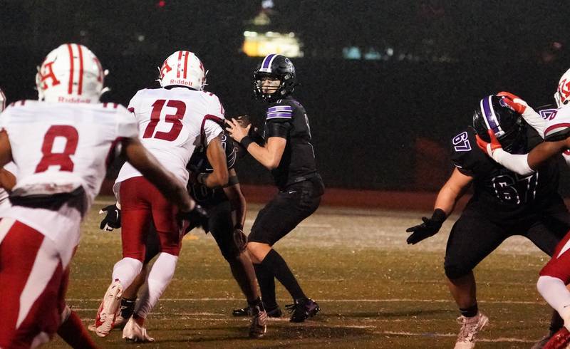 Downers Grove North's Owen Lansu (2) sits in the pocket and looks downfield against Kenwood during a class 7A playoff football game at Downers Grove North on Friday, Oct. 27, 2023.