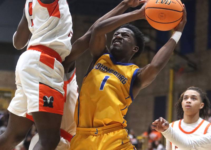 Johnsburg’s Jarrel Albea battles under the hoop against Peoria Manual in boys IHSA Class 2A Supersectional basketball on Monday, Mar. 9, 2026, at Sterling High School in Sterling.