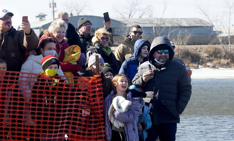 A crowd watches the show from the shore Sunday, Feb. 20, 2022, during the Polar Plunge in Fox Lake. The plunge raised an estimated $52,000 for Special Olympics Illinois.