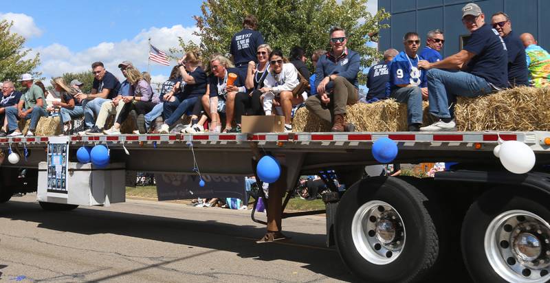 The Princeton High School class of 1989 football team rides a float during the 54th annual Homestead Festival parade on Saturday, Sept. 6, 2025 in Princeton. The team was the runner-up in Class 3A that year.