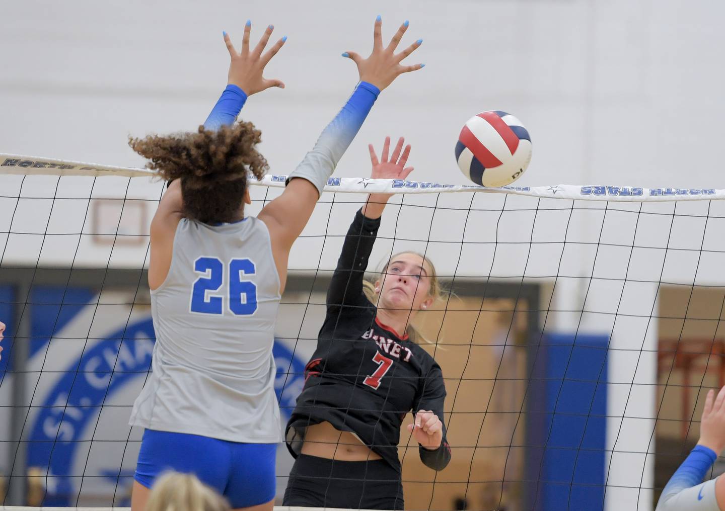 Benet's Audrey Asleson (7) hits the ball past St. Charles North's Sidney Wright (26) during a game on Wednesday, September 20, 2023.