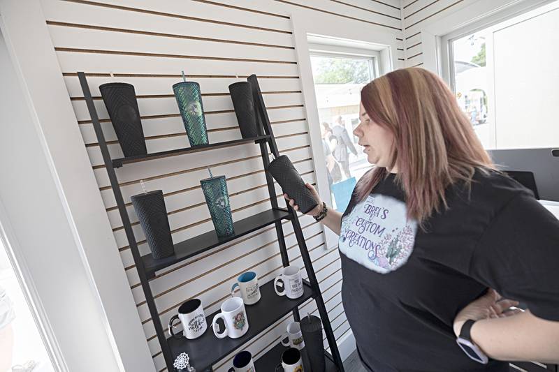 Breanna Litts talks about the customized products in her shop Brea’s Custom Creations Tuesday, June 6, 2023 that opened with the new Shoppes at Grandon.