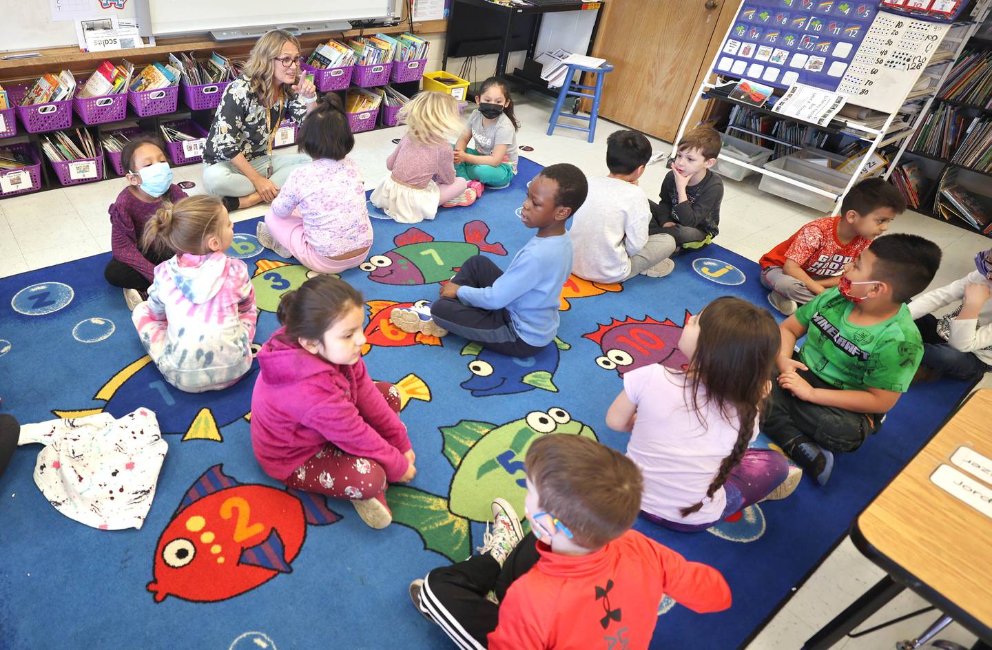 Tracy Paszotta, a kindergarten teacher at Littlejohn Elementary School, greets her students the morning of Monday, March 28, 2022, at the school in DeKalb.