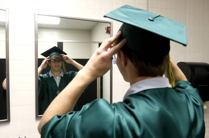Austin Laurie fixes his cap Saturday, May 13, 2023, before the graduation ceremony for class of 2023 at Crystal Lake South High School in Crystal Lake.