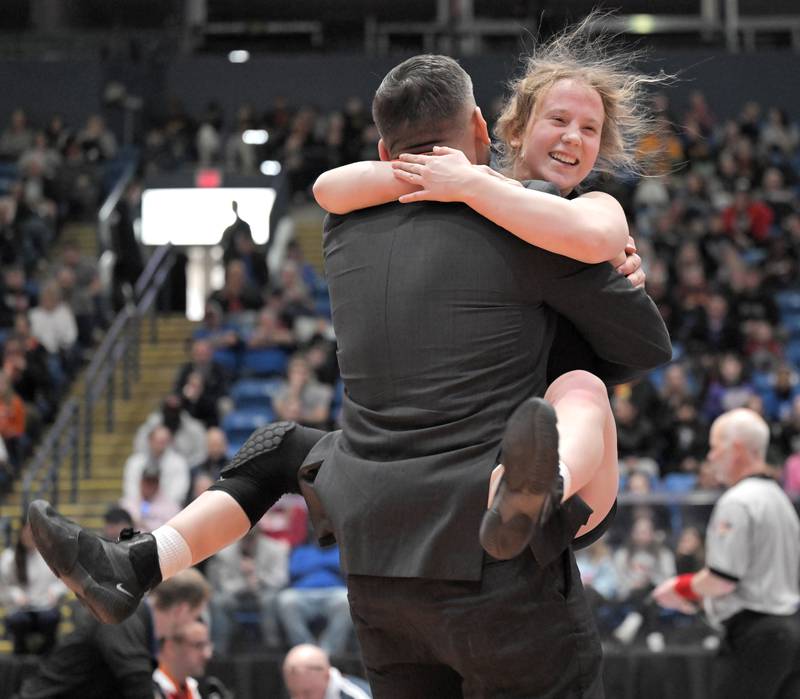 Glenbard East’s Nadiia Shymkiv is declared the winner over Saint Viator’s Charlotte Nold in the 105-pound class at the girls wrestling state finals tournament at Grossinger Arena in Bloomington on Saturday, Feb. 28, 2026.