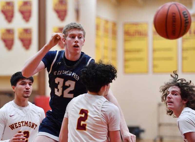 IC Catholic's Andrew Hill (32) makes a jump pass over three Westmont defenders during a game on Jan. 5, 2024 at Westmont High School in Westmont.