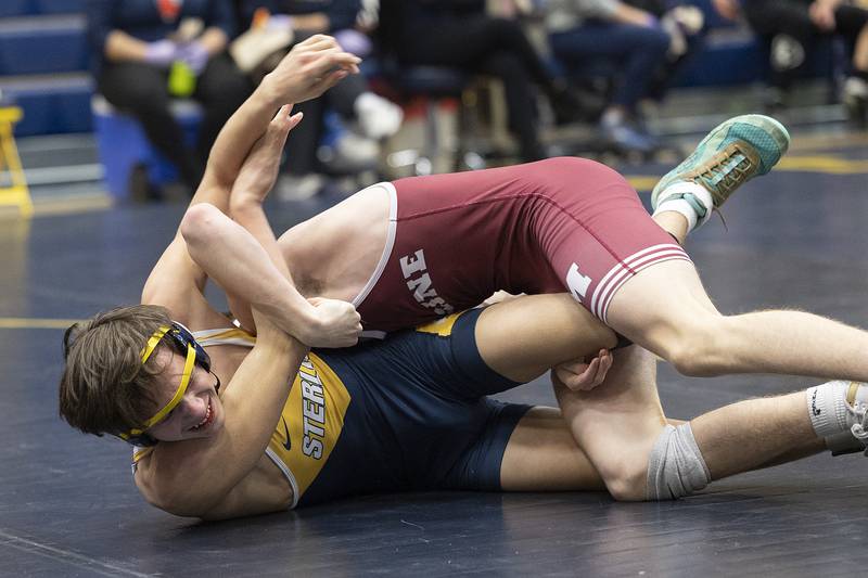 Sterling’s Landon Hackman works against Moline’s Collin Ledbetter in a 120 pound match Friday, Jan. 31, 2025, during the Western Big 6 conference wrestling tournament held at Sterling High School.