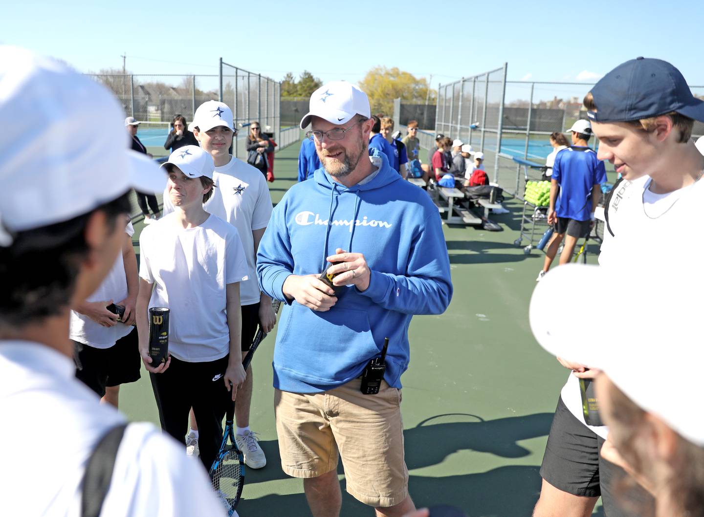 St. Charles North boys varsity tennis Head Coach Sean Masoncup talks to his team before hosting Geneva on Thursday, April 21, 2022. Masoncup’s son, Tyler, is a freshman for Geneva.
