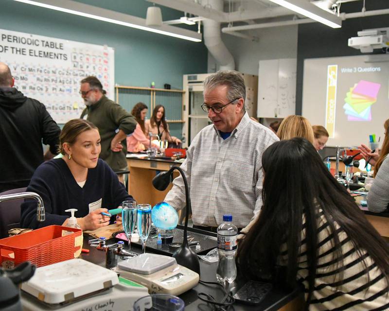 Retired Glenbrook South Science teacher John Lewis walks around and  tries to answer questions and the findings of attendees of the climate of inquiry portion of The Climate of Hope Conference 2024, held at Downers Grove North High School on Friday March 1, 2024.