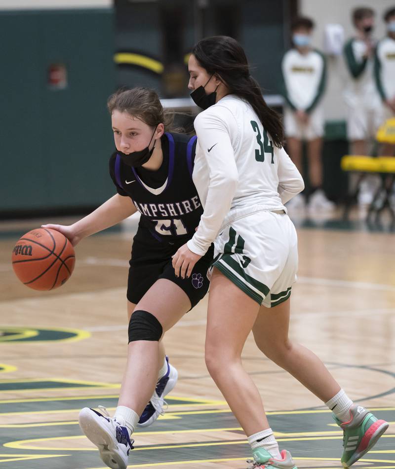 Hampshire's Whitney Thompson pushes past the defense of Crystal Lake South's Olivia Cabrera during their game on Friday, January 14, 2022 at Crystal Lake South High School.