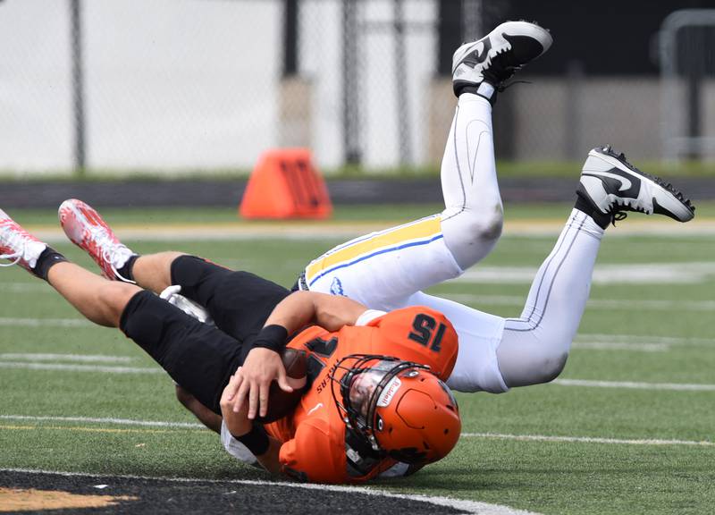 Joe Lewnard/jlewnard@dailyherald.com
Wheaton Warrenville South quarterback Luca Carbonaro gets sacked during Saturday’s game against Simeon.