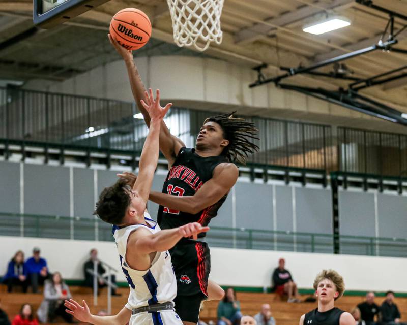 Yorkville's Braydon Porter (22) puts in a contested layup during their Jack Tosh Holiday Classic basketball tournament game between St Francis at Yorkville Thursday Dec 26, 2024 in Elmhurst.