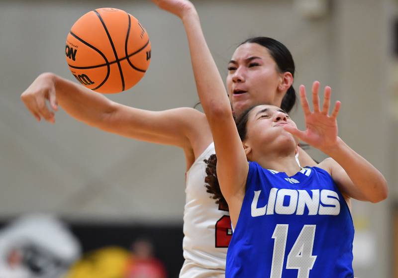 Benet’s Emma Briggs blocks a layup by Lyons Township’s Kennedy Moore (14) during a game on November 18, 2025 at Benet Academy in Lisle.