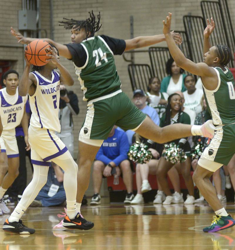 Peoria Richcwood’s Lathan Sommerville works to intercept the pass from Thorton’s Chase Abraham Monday in the 1st Period during the Super Sectional game at Ottawa.