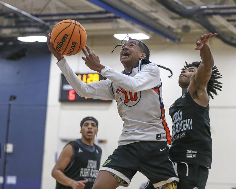 Oswego's Mj Johnson (10) puts in an acrobatic shot  in their Riverside-Brookfield Shootout basketball game.  June 20, 2025 in Riverside.