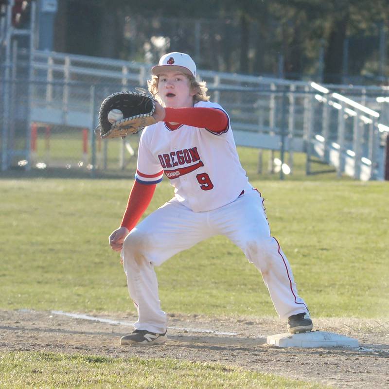 Oregon first baseman Eli Lotz catches a throw for an out against Harvard on Monday, March 23, 2026 at Oregon High School.