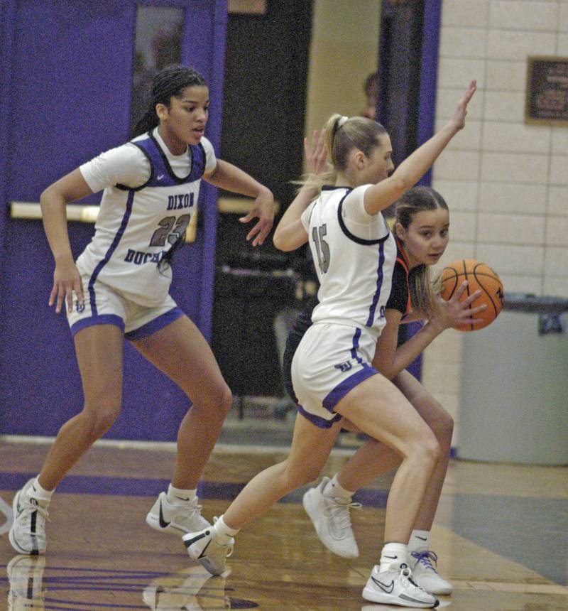 Dixon's Ahmyrie McGowan and Morgan Hargrave defend against a Byron player. The Dixon Duchesses hosted Byron in girls basketball Saturday, Jan. 25, 2025.