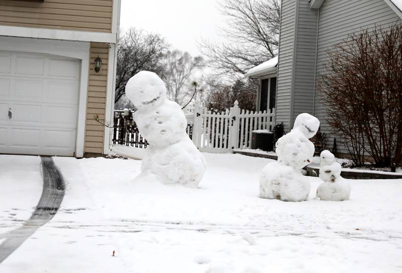 A trio of snowman in a Geneva yard after an overnight snowfall on Tuesday, Jan. 9, 2024.