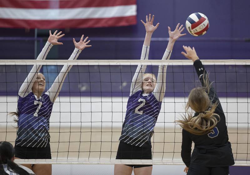 Dixon’s Makenzie Toms and Madyson Tichler go up to block a shot against Newman’s Ellie Rude Monday, August 28, 2023 during a non-conference match-up in Dixon.