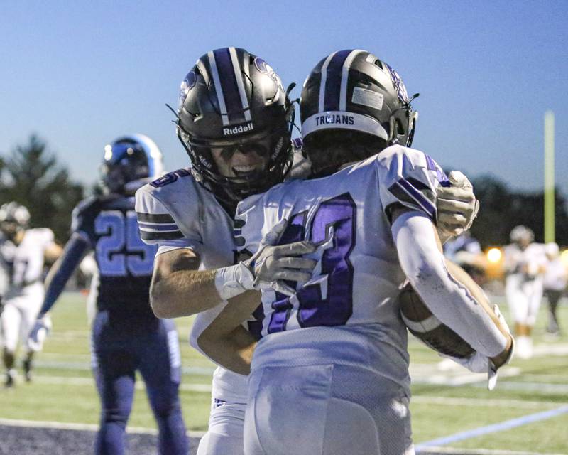 Downers Grove North's Joey Serpico (13) celebrates his touchdown reception with Maxwell Troha (5) during football game between Downers Grove North at Downers Grove South Friday, Sept 5, 2025  in Downers Grove.