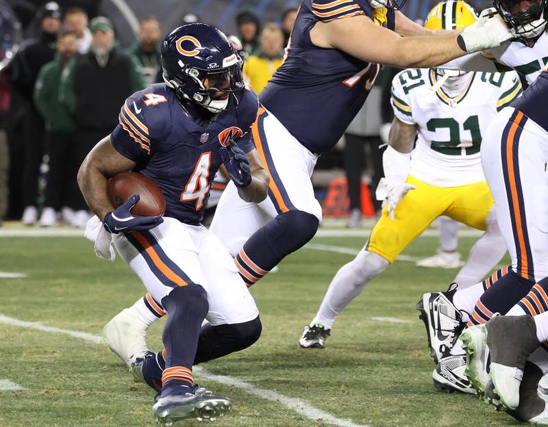 Chicago Bears running back D'Andre Swift looks for an opening in the Green Bay Packer defensive line Saturday, December 20, 2025, during their game at Soldier Field in Chicago.