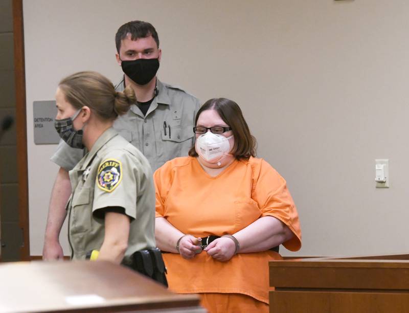 Sarah Lyn (Burton) Safranek, 34, is escorted into the courtroom by two Ogle County baliffs prior to an afternoon hearing on Thursday. She is charged with five counts of first-degree murder and one count of aggravated battery of her son, Nathaniel. She is being held in the Ogle County Jail on $2 million bond.
