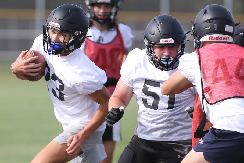 Sycamore’s Dylan Hodges follows the blocking of teammate Gable Carrick during practice Monday, Aug. 7, 2023, at Sycamore High School.