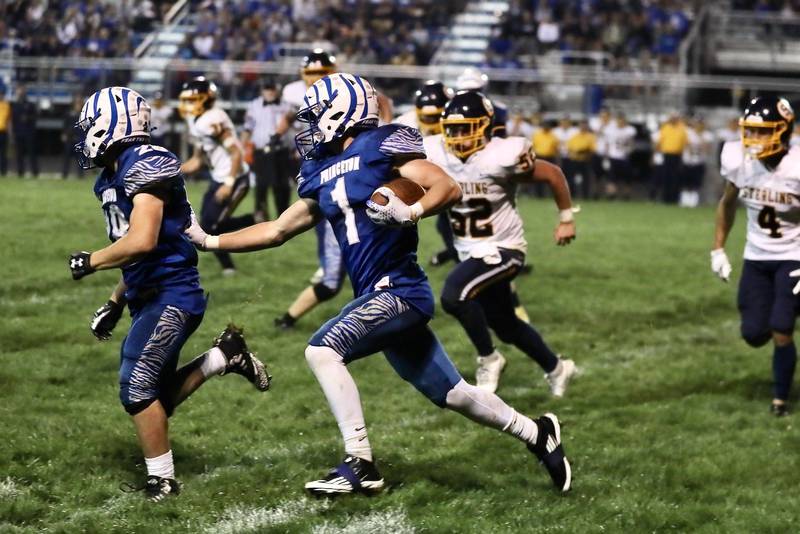 Princeton's Casey Etheridge uses the block of running mate Preston Arkels against Sterling Friday night at Bryant Field. The Tigers won 28-6.