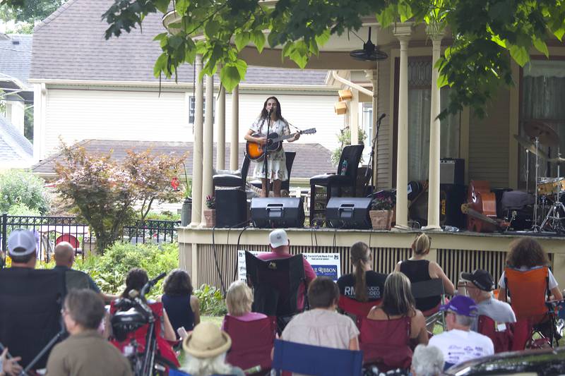 Lucy Isabel, a folk/Americana singer-songwriter, erforms in the 600 block of Western Avenue in Joliet as part of the Porch and Park Music Fest on Saturday, Aug. 16, 2025.