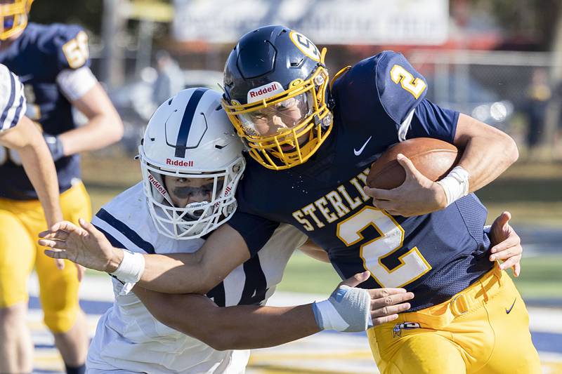 Sterling’s JP Schilling is hit by St. Viator’s Phu Truong in their first round playoff game Saturday, Oct. 29, 2022.