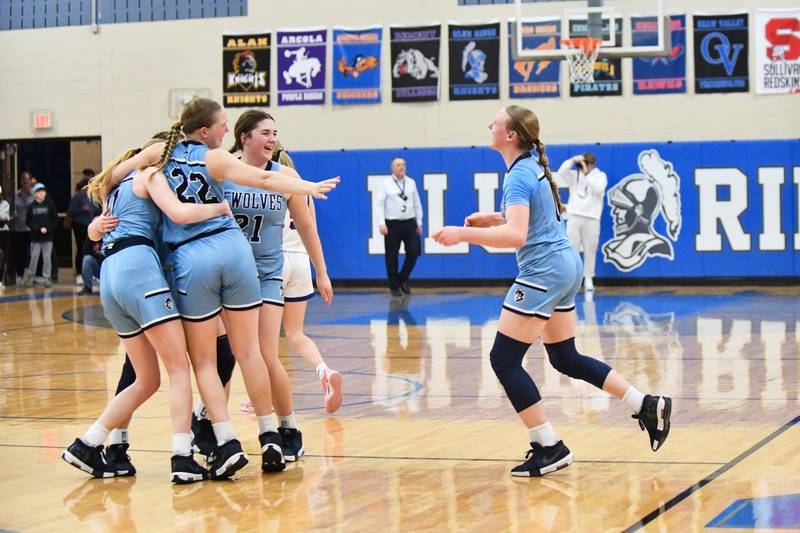 Cissna Park's Josie Neukomm (22) reaches out for teammate Addison Lucht as the team celebrates their 47-35 victory over St. Teresa in the IHSA Class 1A Blue Ridge Super-Sectional on Monday, March 3.