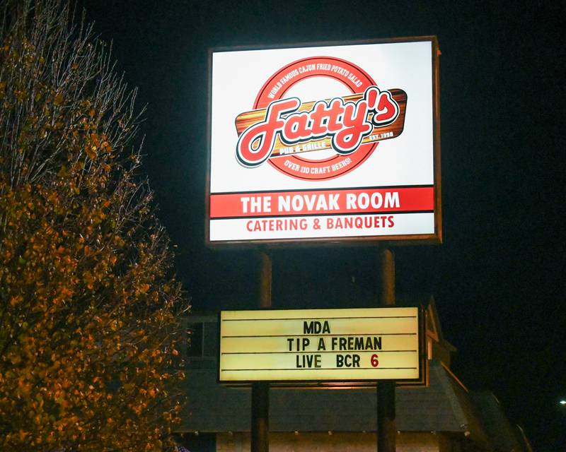 Signs advertise the DeKalb Fire Department's annual charitable event on Wednesday, Nov. 27, 2024, outside Fatty's Pub and Grille in DeKalb during the DeKalb Fire Fighters Local 1236 union's Tip A Firefighter event to fundraise for the Muscular Dystrophy Association.