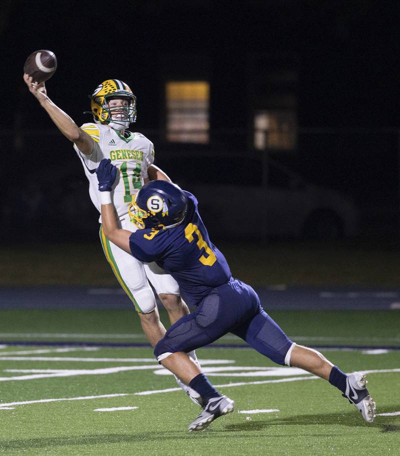 Geneseo QB Jackson McAvoy is hit as he throws by Sterling’s Cobey Shipma Friday, Oct. 4, 2024, at Sterling High School.