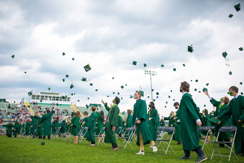 Graduates toss their caps after the conclusion of the 4 p.m. commencement ceremony of the Crystal Lake South High School Class of 2021 at the school's football stadium on Sunday, May 16, 2021, in Crystal Lake.