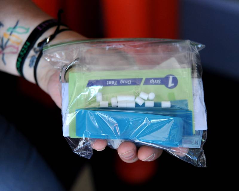 Laura Fry, the executive director of Live4Lali, holds a drug test kit before a meeting Monday, June 27, 2022, of the McHenry County Substance Abuse Coalition in Crystal Lake. Live4Lali is one of nearly 60 agencies being asked how McHenry County should spend the Big Pharma settlement in battling opioid addiction in McHenry County.